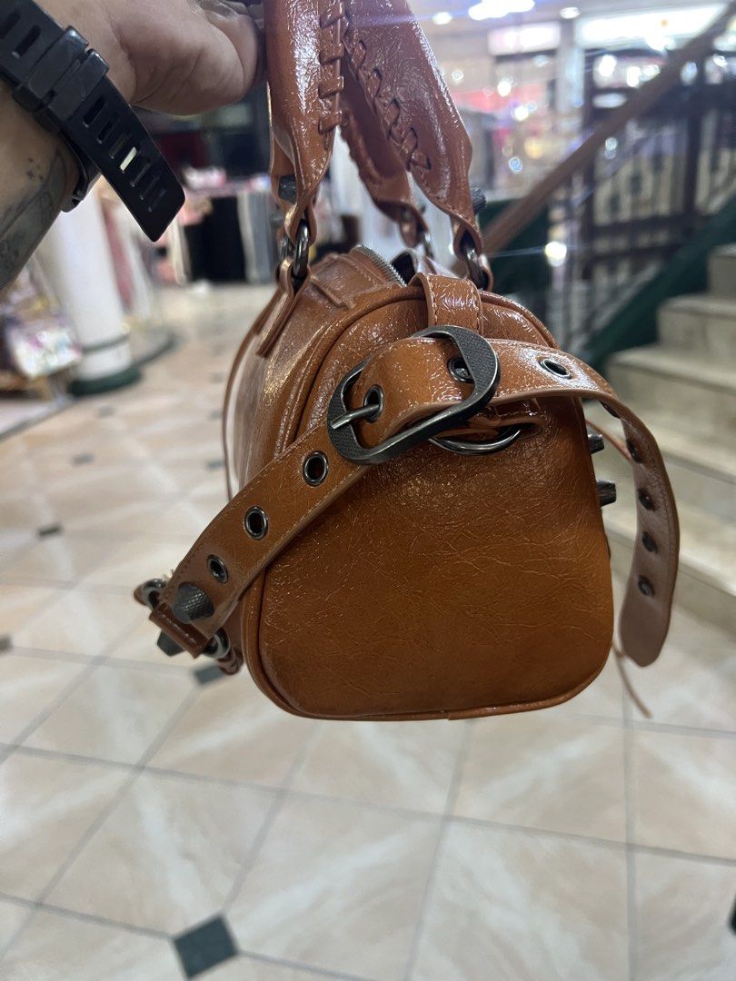 Brown Studded Shoulder Bag with BB Zipper (Category: Shoulder Bags) located in Bago City. Submitted by g___shop (Listing ID 1449792635, Image 2). Description: - Cool brown shoulder bag - Shiny finish with stud details - With mirror and heart keychain - Comes with dust bag - BB logo zipper pull - Like new - Detachable strap included - Spacious interior for essentials - Versatile for everyday or night out - Unique and eye-catching design.