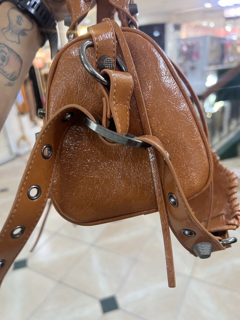 Brown Studded Shoulder Bag with BB Zipper (Category: Shoulder Bags) located in Bago City. Submitted by g___shop (Listing ID 1449792635, Image 3). Description: - Cool brown shoulder bag - Shiny finish with stud details - With mirror and heart keychain - Comes with dust bag - BB logo zipper pull - Like new - Detachable strap included - Spacious interior for essentials - Versatile for everyday or night out - Unique and eye-catching design.
