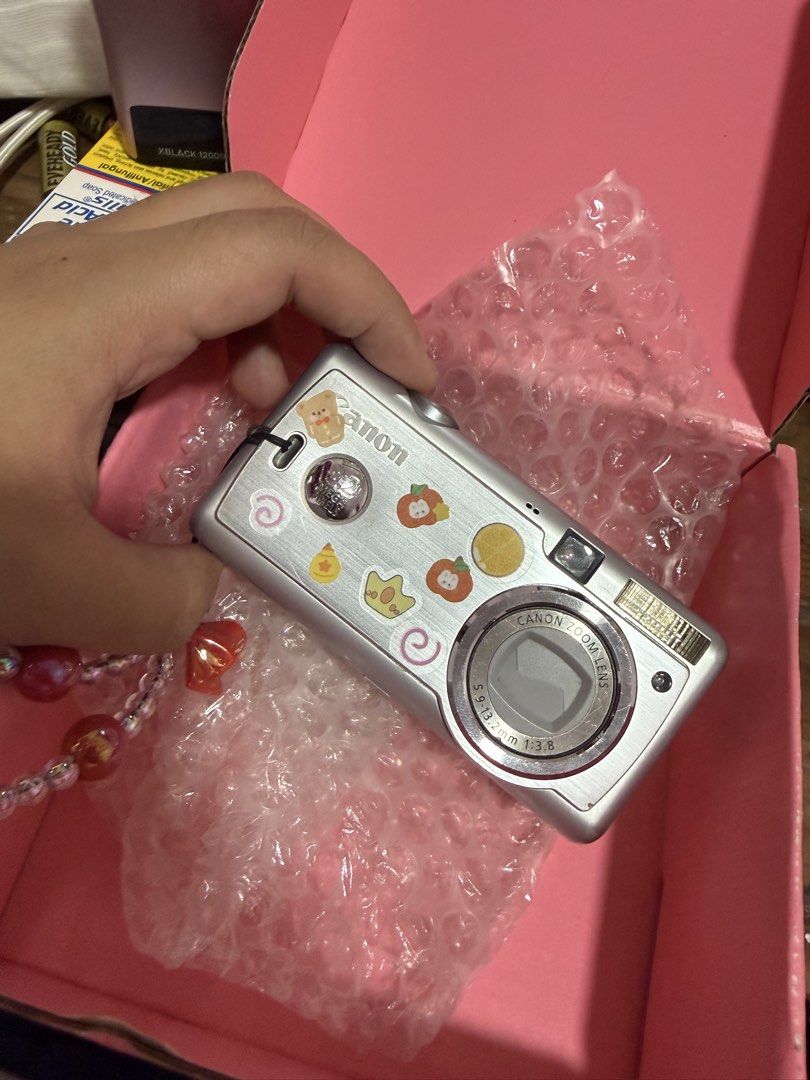 Canon Powershot a400 (Category: Cameras) located in Manila. Submitted by carmexxgam34868 (Listing ID 1449902398, Image 1). Description: NEGOTIABLE - Silver Canon digital camera - Includes beaded strap - Features cute stickers on the front - All buttons are present and functional - Ready for your next adventure! Issue: LCD WRAP 8/10 body condition .