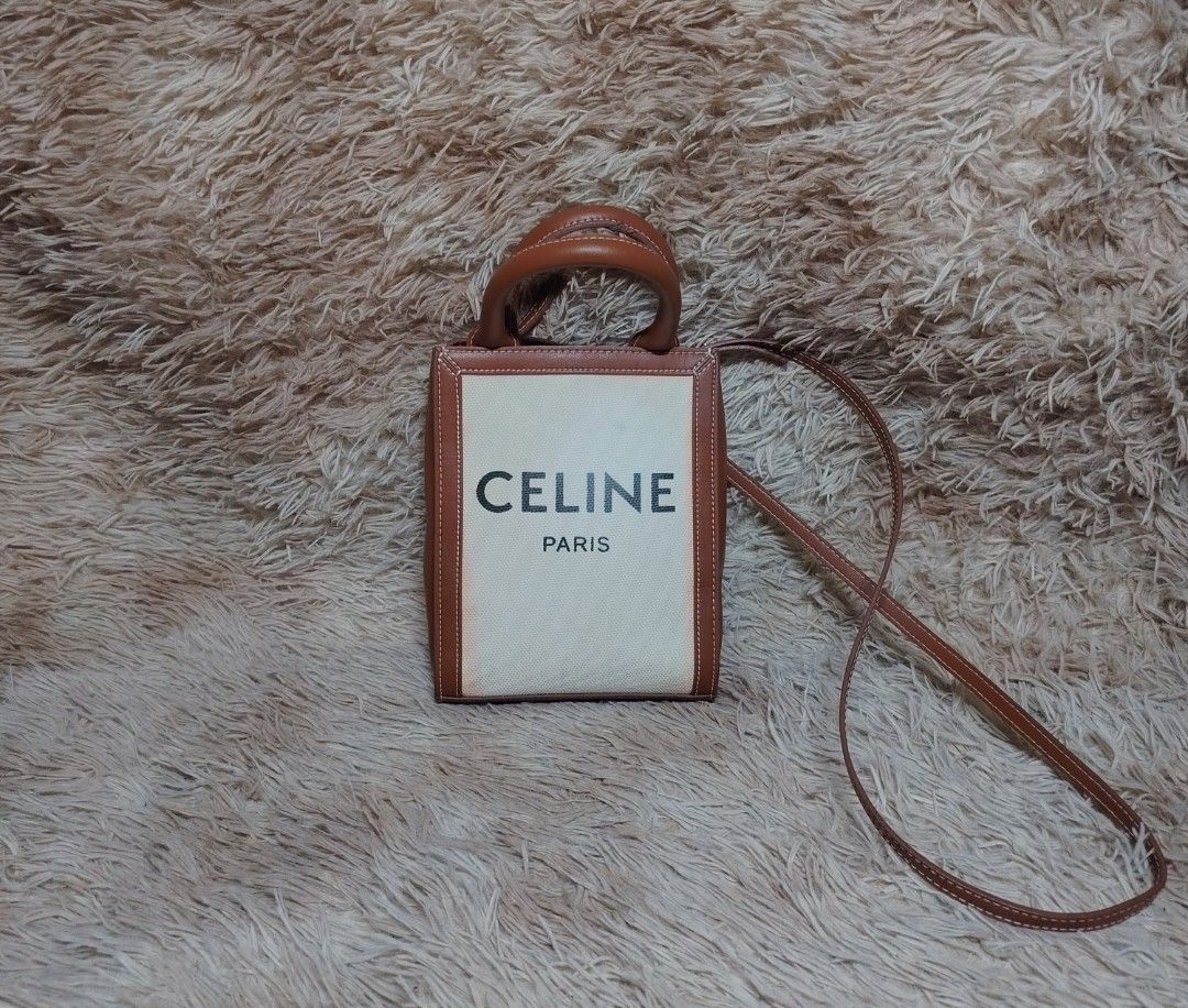 CELINE MINI VERTICAL CANVAS TOTE BAG👜 (Category: Luxury Bags & Wallets) located in Bislig. Submitted by tuazons21 (Listing ID 1449927455, Image 1). Description: CELINE MINI VERTICAL CANVAS TOTE BAG👜 RANK B GOOD CONDITION DETAILS POSTED⤵️ 1,500💸 - Specs: Mini vertical silhouette — compact yet roomy enough for daily essentials (phone, wallet, keys, small cosmetics). Features gold-tone hardware, official MADE IN ITALY marking, and matching canvas