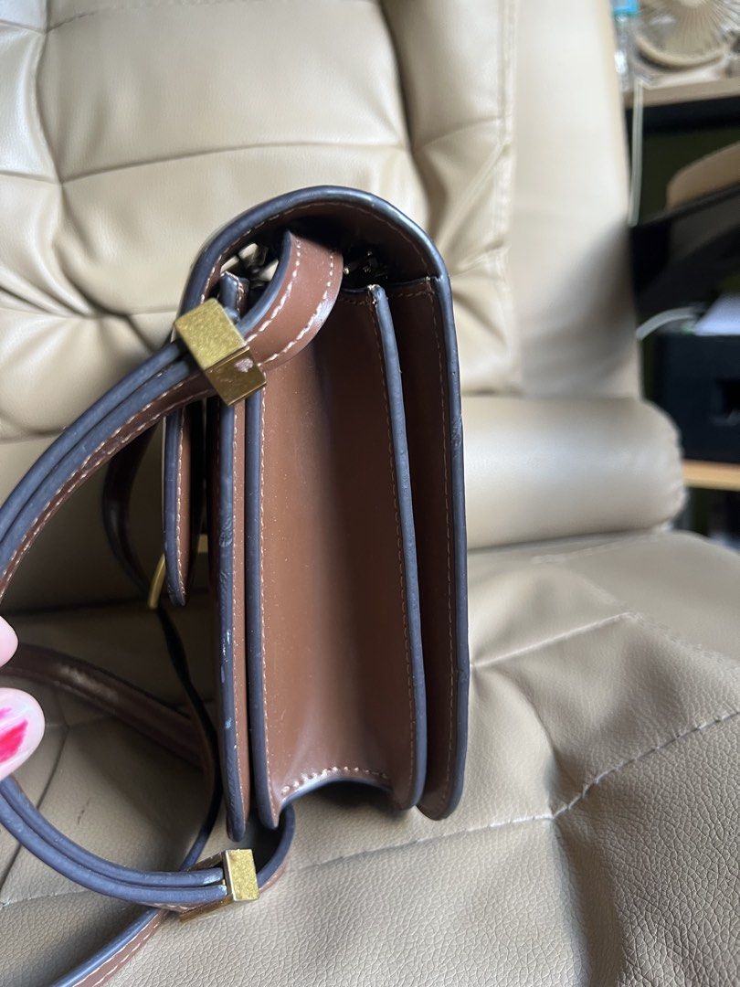 Celine Paris Brown Leather Crossbody Bag (Category: Cross-body Bags) located in Saravia. Submitted by clynlyn (Listing ID 1449853248, Image 2). Description: - Authentic Celine Paris brown leather crossbody bag - Elegant gold-tone clasp closure - Spacious main compartment with an interior zippered pocket - Adjustable strap for comfortable wear - Expertly crafted in Italy - Shows minor scuffs on the exterior, but remains in good overall condition.