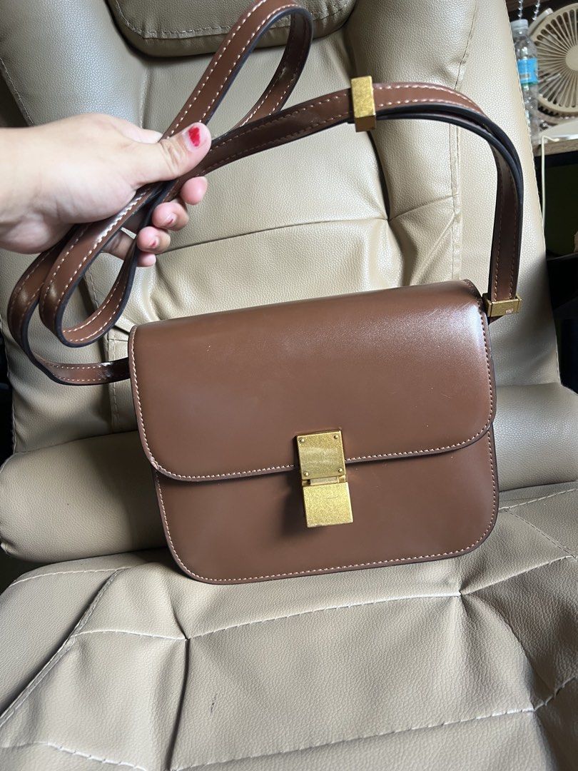 Celine Paris Brown Leather Crossbody Bag (Category: Cross-body Bags) located in Saravia. Submitted by clynlyn (Listing ID 1449853248, Image 1). Description: - Authentic Celine Paris brown leather crossbody bag - Elegant gold-tone clasp closure - Spacious main compartment with an interior zippered pocket - Adjustable strap for comfortable wear - Expertly crafted in Italy - Shows minor scuffs on the exterior, but remains in good overall condition.