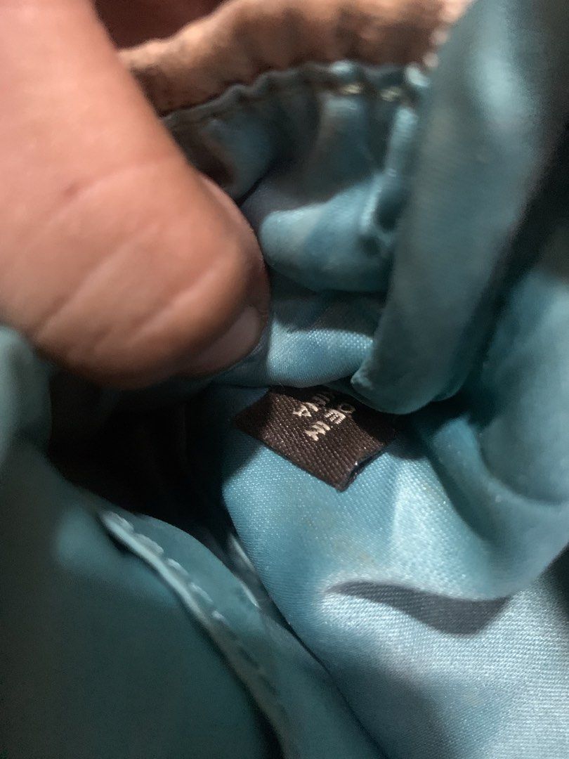 Coach Monogram Pouch/Cosmetic Bag (Category: Luxury Bags & Wallets) located in Cagayan de Oro. Submitted by agboysalis60090 (Listing ID 1449780246, Image 3). Description: Authentic Coach pouch. Tan/beige color with signature C monogram pattern. Zipper closure. Interior is lined in a bright teal. Small stain on the front, as pictured. Leather tag attached. Great for makeup or small essentials..