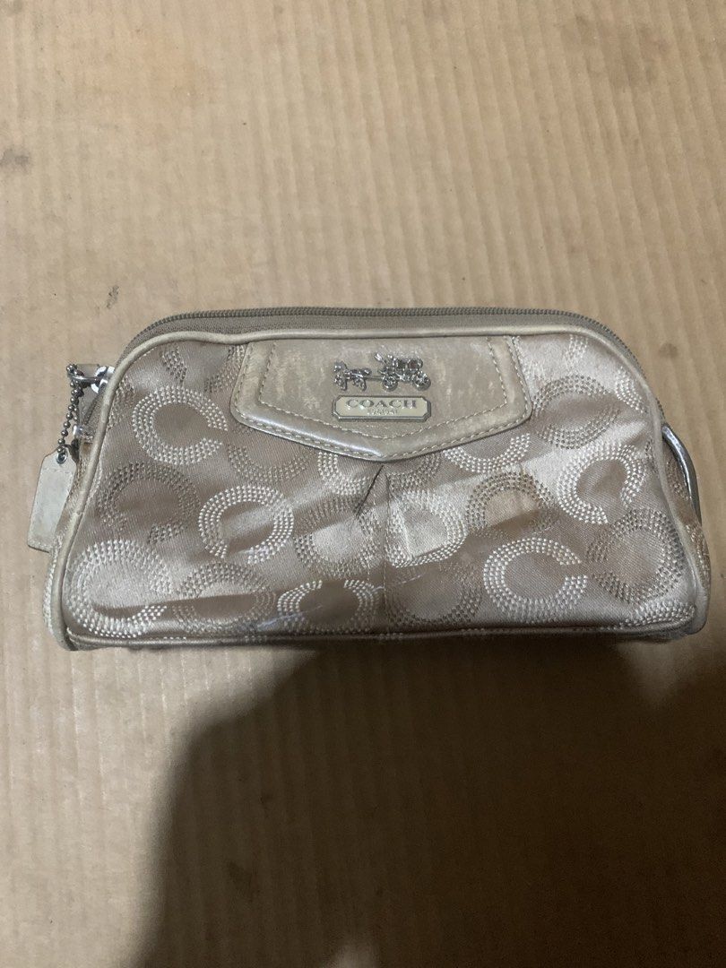 Coach Monogram Pouch/Cosmetic Bag (Category: Luxury Bags & Wallets) located in Cagayan de Oro. Submitted by agboysalis60090 (Listing ID 1449780246, Image 1). Description: Authentic Coach pouch. Tan/beige color with signature C monogram pattern. Zipper closure. Interior is lined in a bright teal. Small stain on the front, as pictured. Leather tag attached. Great for makeup or small essentials..
