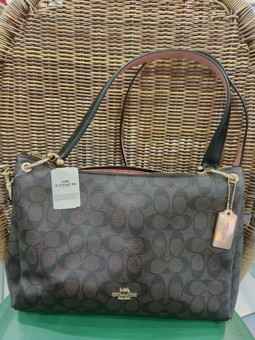 Coach Signature Monogram Brown Shoulder Bag (Category: Luxury Bags & Wallets) located in Manila. Submitted by macchi1216 (Listing ID 1449904782, Image 2). Description: - Authentic Coach shoulder bag - Signature monogram print in brown - Black straps and pink interior lining - Gold hardware details - Zipper closure - Comes with Coach tag and charm - with issue inside creed patch .