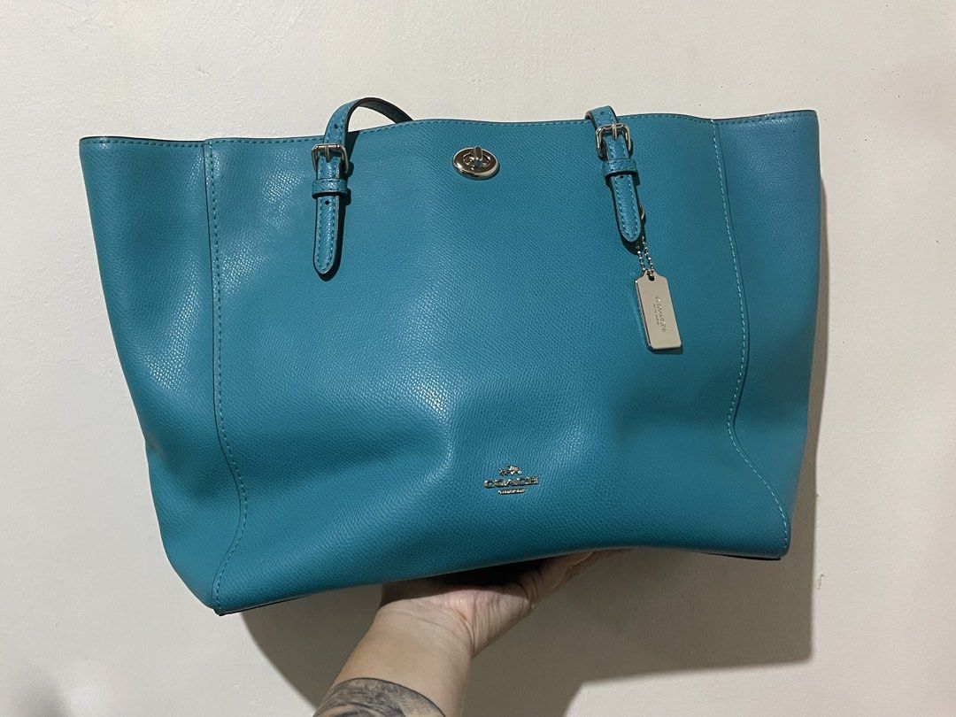 Coach Turquoise Pebbled Leather Tote Bag (Category: Luxury Bags & Wallets) located in Bulacan. Submitted by chelseysclo (Listing ID 1449819599, Image 1). Description: coach turnlock tote 36454 Turquoise pebbled leather tote bag from Coach. Silver hardware details. Includes a Coach leather hangtag. Spacious interior, great for everyday use. Top handles for carrying. Clean and simple design..