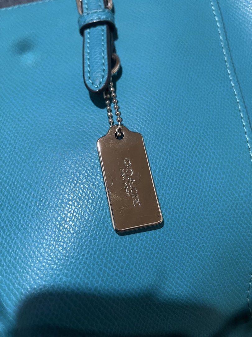 Coach Turquoise Pebbled Leather Tote Bag (Category: Luxury Bags & Wallets) located in Bulacan. Submitted by chelseysclo (Listing ID 1449819599, Image 2). Description: coach turnlock tote 36454 Turquoise pebbled leather tote bag from Coach. Silver hardware details. Includes a Coach leather hangtag. Spacious interior, great for everyday use. Top handles for carrying. Clean and simple design..