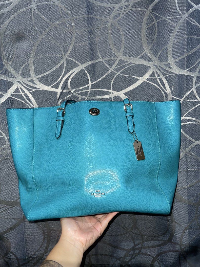 Coach Turquoise Pebbled Leather Tote Bag (Category: Luxury Bags & Wallets) located in Bulacan. Submitted by chelseysclo (Listing ID 1449819599, Image 3). Description: coach turnlock tote 36454 Turquoise pebbled leather tote bag from Coach. Silver hardware details. Includes a Coach leather hangtag. Spacious interior, great for everyday use. Top handles for carrying. Clean and simple design..