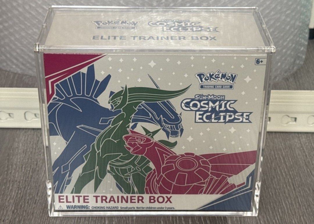 Cosmic Eclipse ETB (Category: Card Boxes & Cases) located in Singapore. Submitted by printsandpatterns (Listing ID 1449796844, Image 1). Description: MINT Cosmic Eclipse Current bid $3200 Will release to any higher offers PM me 🙏🏼 Brand new, Mint, No tears/ holes/ defects.