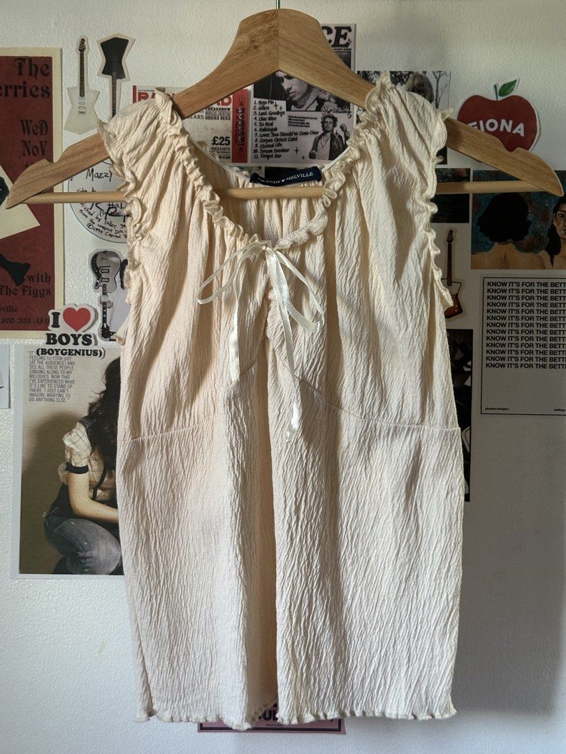 Cream Textured Ruffle Neck Tie Top (Category: Sleeveless) located in Manila. Submitted by ohmgee (Listing ID 1449822222, Image 1). Description: - Tag says Brandy Melville.