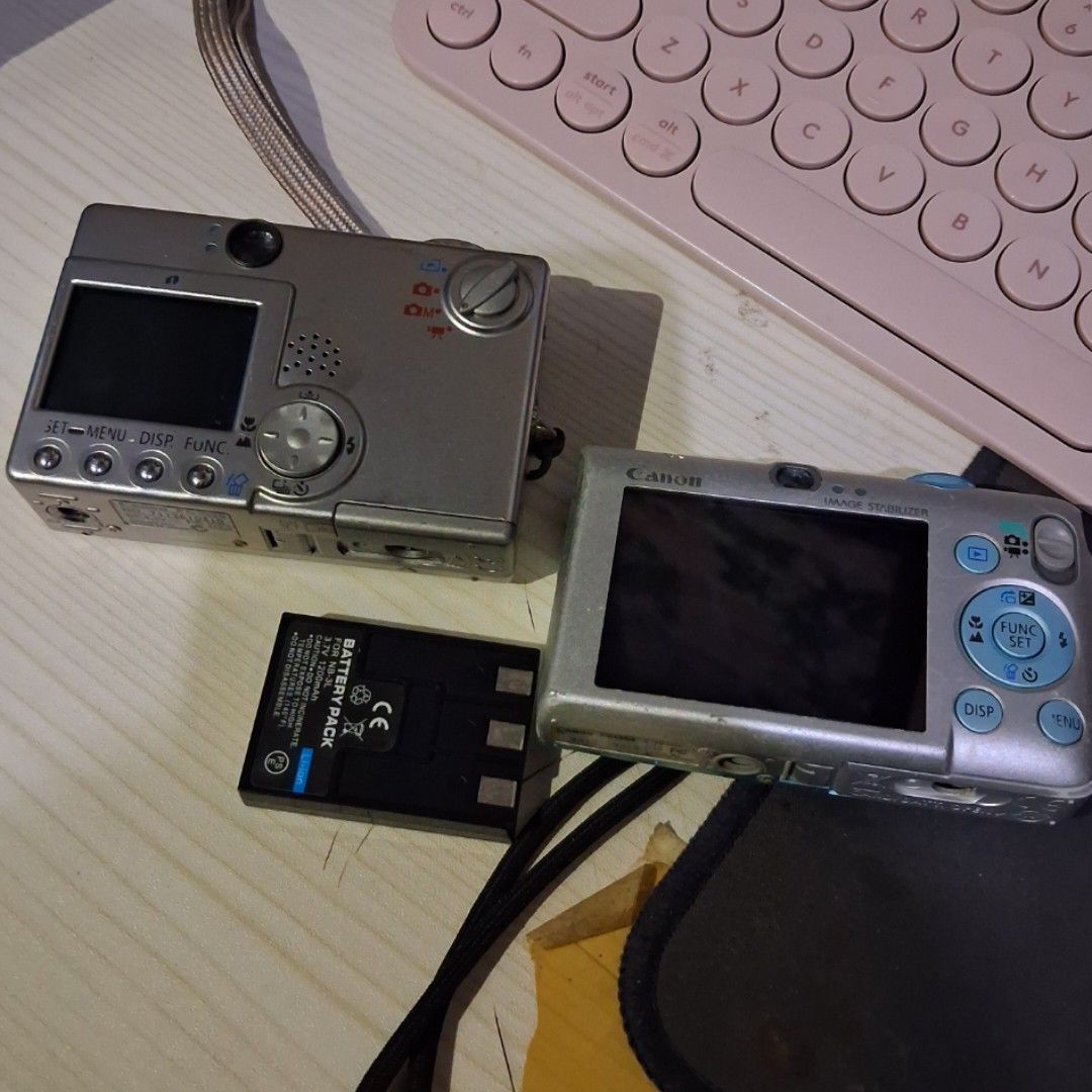 Defective Digital Cameras (Canon) + NBL 3 battery (Category: Cameras) located in Cebu City. Submitted by kirbyvv (Listing ID 1449876984, Image 2). Description: Canon digicams defective -with working nbl 3 battery issues: - [gray] has lcd problems - [blue] won't turn on, for parts 250 each cam 100 battery 450 if all.