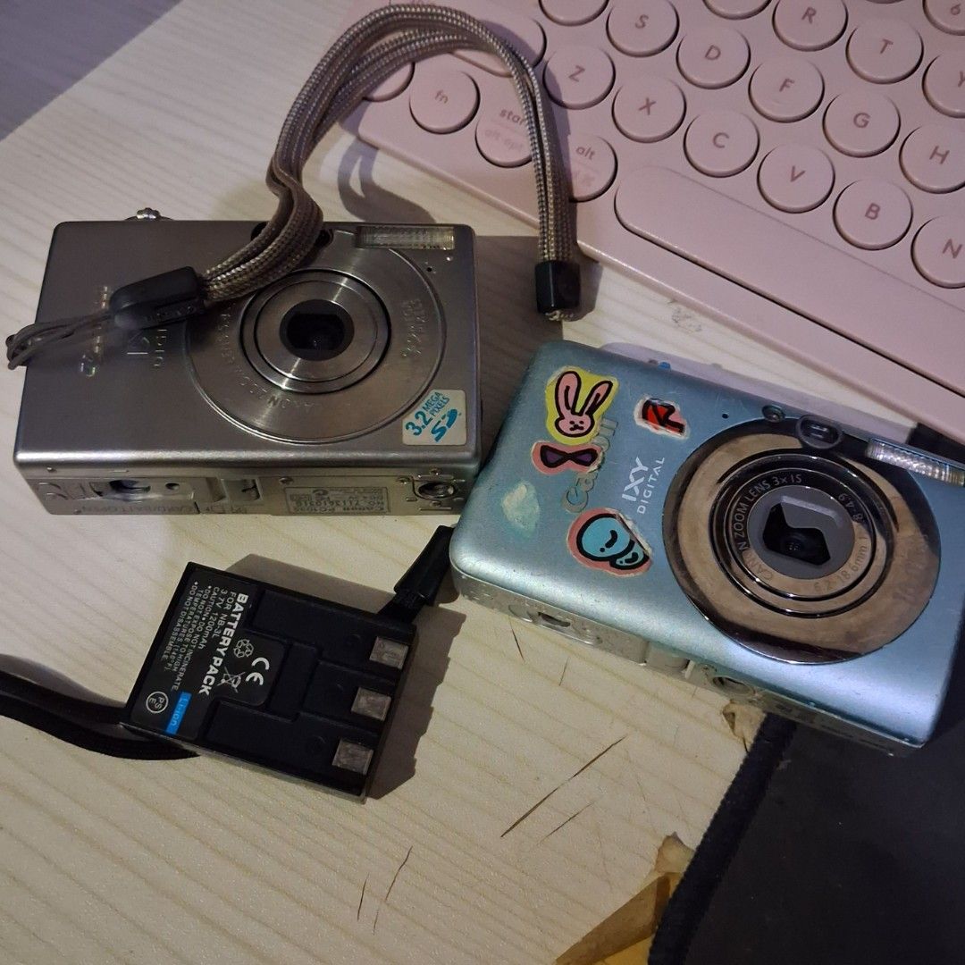 Defective Digital Cameras (Canon) + NBL 3 battery (Category: Cameras) located in Cebu City. Submitted by kirbyvv (Listing ID 1449876984, Image 1). Description: Canon digicams defective -with working nbl 3 battery issues: - [gray] has lcd problems - [blue] won't turn on, for parts 250 each cam 100 battery 450 if all.