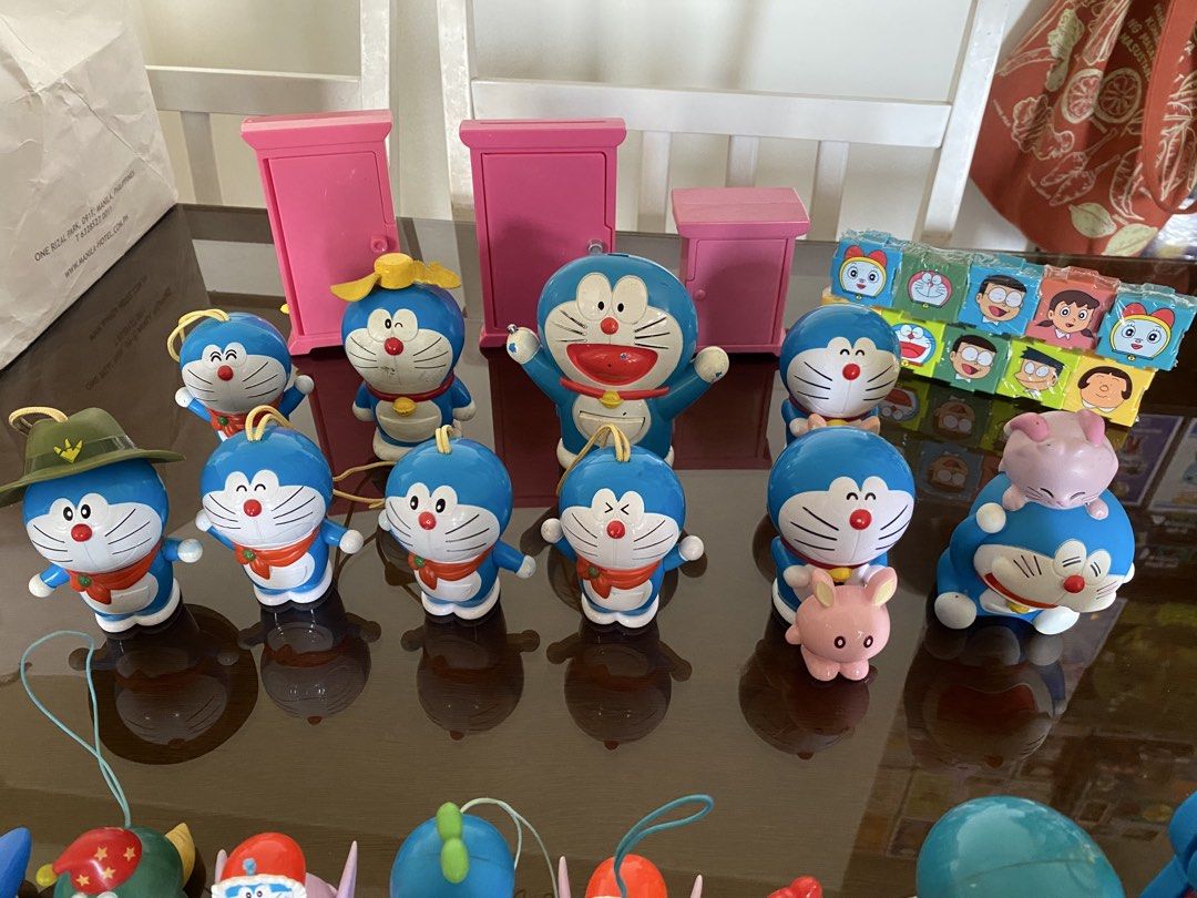 Doraemon Figurines, Keychains, and Mini Projectors (Category: Character Goods) located in Manila. Submitted by declutterthingzzz (Listing ID 1449822182, Image 3). Description: Selling a collection of Doraemon toys. Includes various figurines, some with pull-strings or keychains. Also have mini projectors with Doraemon characters. Some pink cabinet-like structures are included too. Great for any Doraemon fan. All items are from the images provided