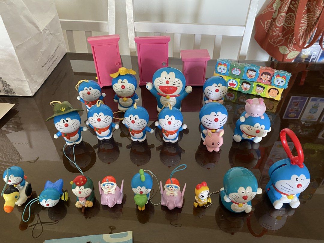 Doraemon Figurines, Keychains, and Mini Projectors (Category: Character Goods) located in Manila. Submitted by declutterthingzzz (Listing ID 1449822182, Image 2). Description: Selling a collection of Doraemon toys. Includes various figurines, some with pull-strings or keychains. Also have mini projectors with Doraemon characters. Some pink cabinet-like structures are included too. Great for any Doraemon fan. All items are from the images provided