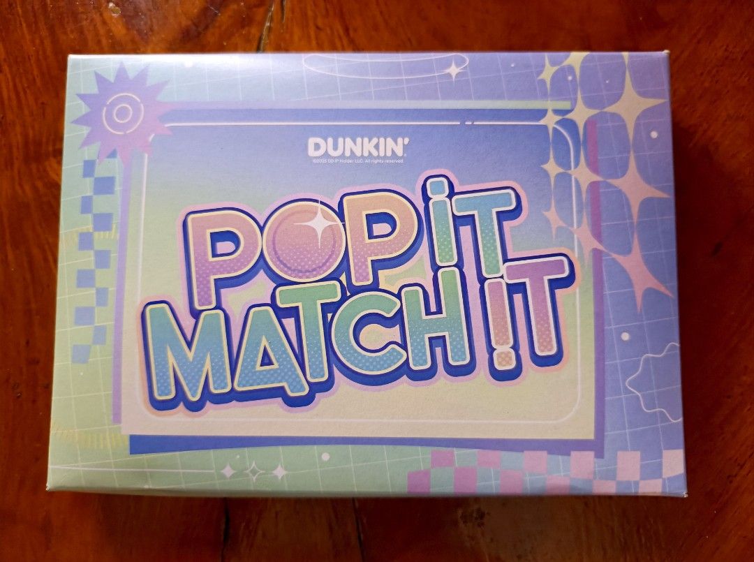 Dunkin' X TXT Pop It Match It Game (Category: Board Games & Puzzles) located in Claveria. Submitted by raiserx (Listing ID 1449819607, Image 1). Description: - Dunkin' Pop It Match It Game - Interactive memory matching game - Flip cards and find matching pairs - Collect the most pairs to win - Includes instructions - Perfect for family game nights.