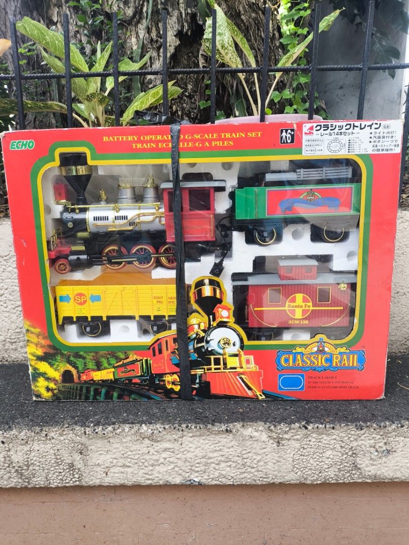 Echo Classic Rail Battery Operated Scale Train Set (Category: Vehicle & Diecast Models) located in Muntinlupa City. Submitted by ahldreenra69805 (Listing ID 1449831718, Image 1). Description: - Classic battery-operated train set - Includes locomotive, tender, freight car, and caboose - Plenty of track pieces for a circular layout - Detailed locomotive with gold accents - Freight car comes with a load of wood - Batteries are included in the tender