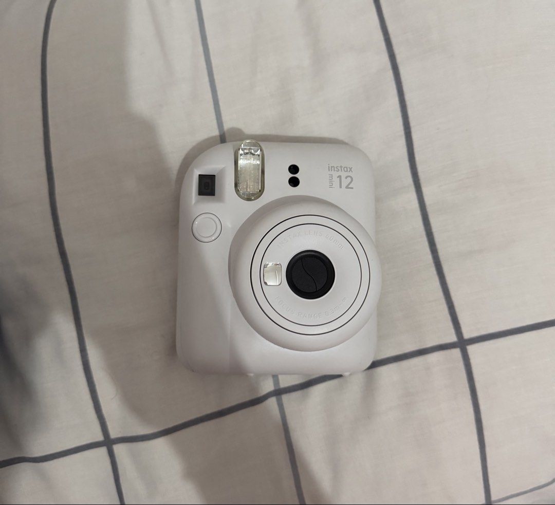 Fujifilm Instax Mini 12 Instant Camera (Category: Cameras) located in Quezon City. Submitted by torturedpoets (Listing ID 1449786416, Image 1). Description: - color: Clay White - includes original box, manual, and strap - used once - batteries not included mop: gcash/maribank buyer will shoulder sf loc: quezon city.