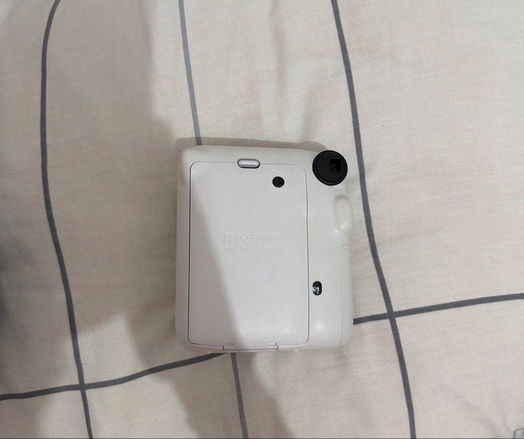Fujifilm Instax Mini 12 Instant Camera (Category: Cameras) located in Quezon City. Submitted by torturedpoets (Listing ID 1449786416, Image 2). Description: - color: Clay White - includes original box, manual, and strap - used once - batteries not included mop: gcash/maribank buyer will shoulder sf loc: quezon city.