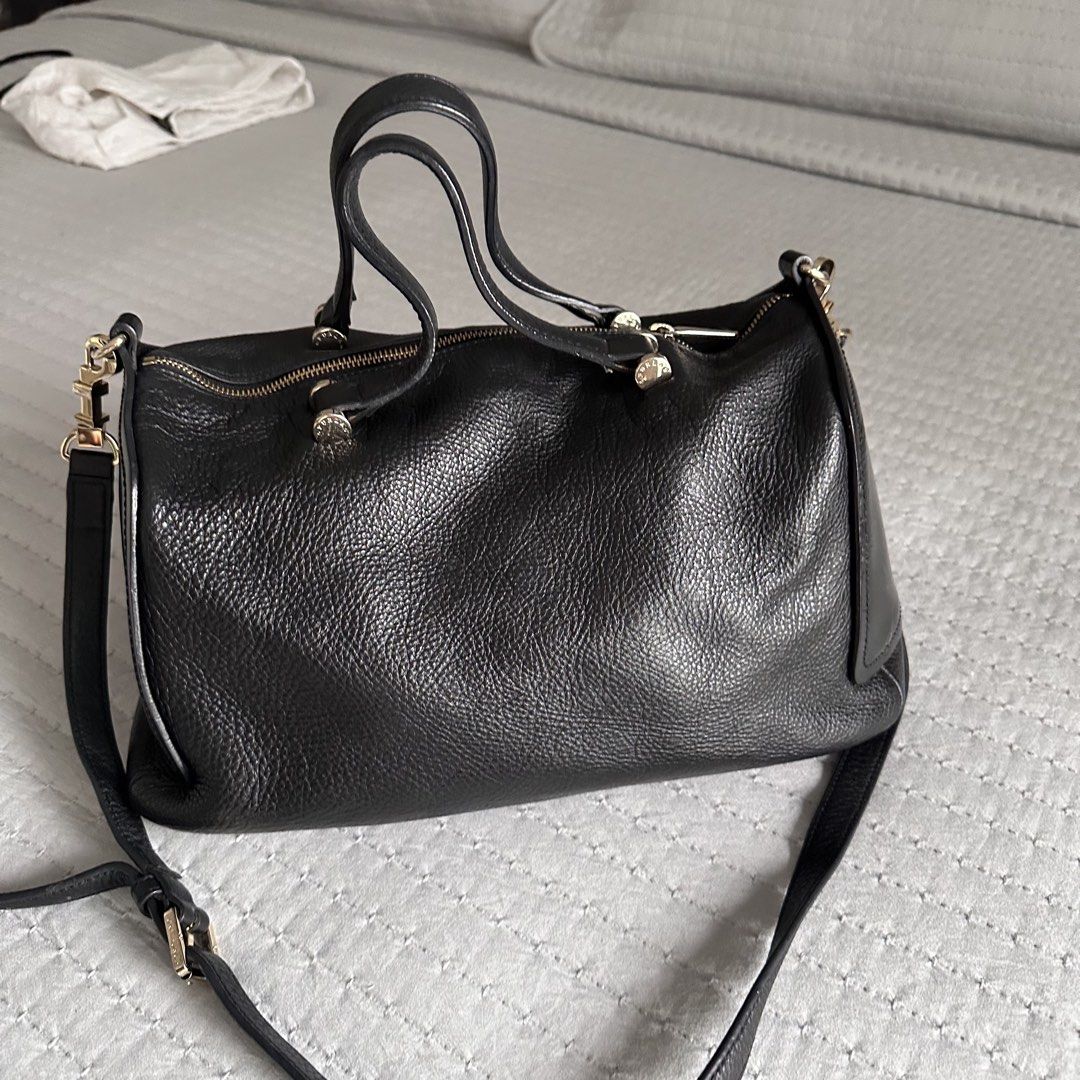 Furla Black Grained Leather Boston Bag (Category: Luxury Bags & Wallets) located in Antipolo. Submitted by fasph (Listing ID 1449753118, Image 1). Description: - Brand: Furla - Color: Black - Material: Textured leather exterior with smooth leather accents - Features: Top handles, detachable shoulder strap, gold-tone hardware, zipper closure - Condition: Minor scuffing on side leather - Interior: Spacious, perfect for essentials.