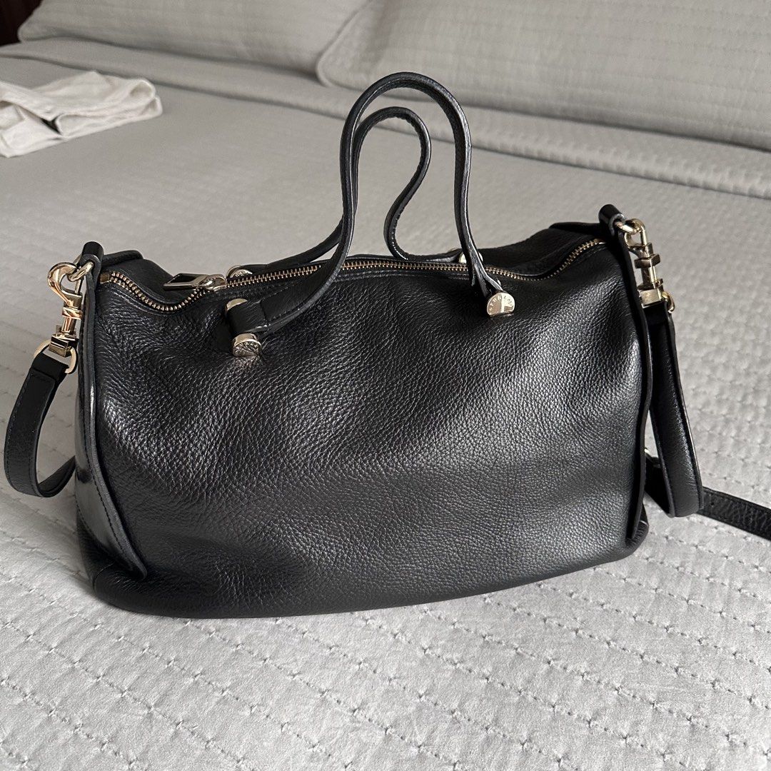 Furla Black Grained Leather Boston Bag (Category: Luxury Bags & Wallets) located in Antipolo. Submitted by fasph (Listing ID 1449753118, Image 2). Description: - Brand: Furla - Color: Black - Material: Textured leather exterior with smooth leather accents - Features: Top handles, detachable shoulder strap, gold-tone hardware, zipper closure - Condition: Minor scuffing on side leather - Interior: Spacious, perfect for essentials.
