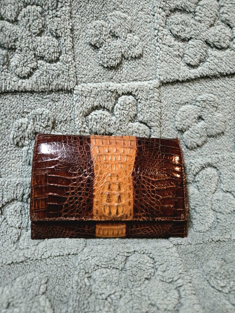 Genuine Crocodile Leather Wallet (Category: Wallets & Card holders) located in Manila. Submitted by oki.ukay (Listing ID 1449893750, Image 1). Description: - Genuine crocodile leather wallet - Classic brown with a tan stripe down the middle - Secure clasp closure - Internal zippered compartment - Plenty of space for cards and cash - A sophisticated and durable accessory.