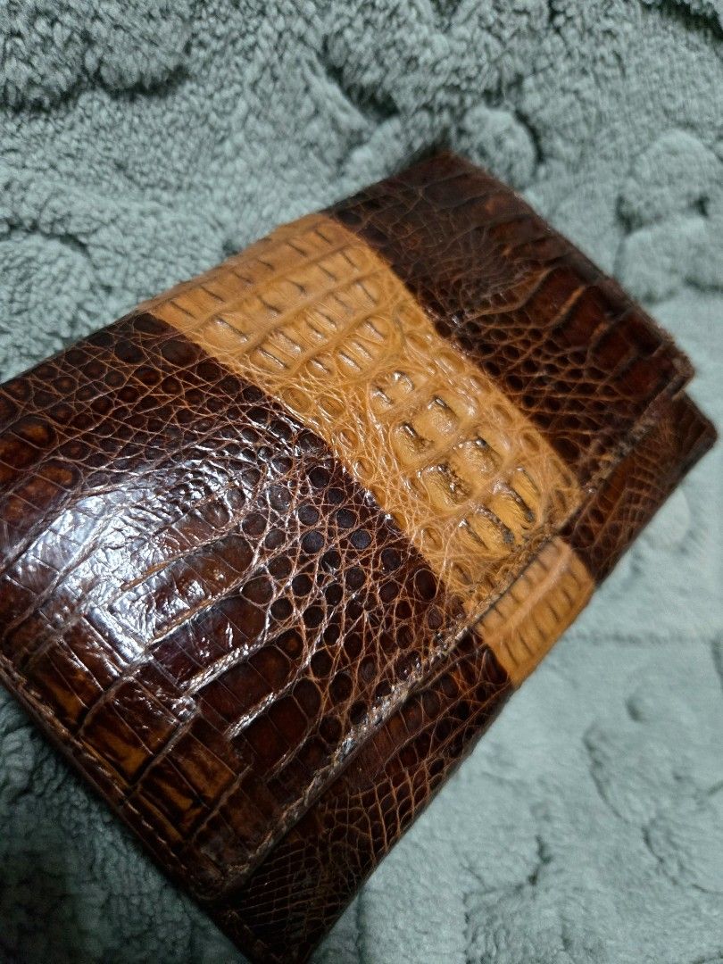 Genuine Crocodile Leather Wallet (Category: Wallets & Card holders) located in Manila. Submitted by oki.ukay (Listing ID 1449893750, Image 3). Description: - Genuine crocodile leather wallet - Classic brown with a tan stripe down the middle - Secure clasp closure - Internal zippered compartment - Plenty of space for cards and cash - A sophisticated and durable accessory.