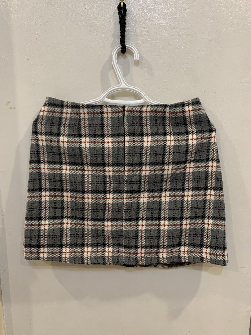 Grey Plaid Wrap Mini A-Line Skirt with Buttons (Category: Skirts) located in Caloocan City. Submitted by starrytaro (Listing ID 1449932300, Image 2). Description: - Grey plaid wrap skirt - Features three buttons on the side for closure - Nice textured fabric - Pairs well with boots or sneakers - Suitable for casual or slightly dressed-up occasions.