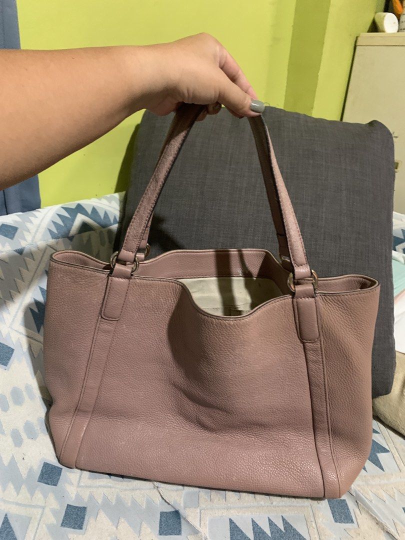 Gucci Pink Leather Monogram Tote Bag (Category: Luxury Bags & Wallets) located in Liloan. Submitted by jinalyns (Listing ID 1449900371, Image 2). Description: Gucci tote bag in a lovely pink shade. Made from textured leather. Features the iconic GG monogram embossed on the front. Spacious interior with a zippered pocket. The bottom has protective studs. Handles show some signs of wear. A classic everyday bag..