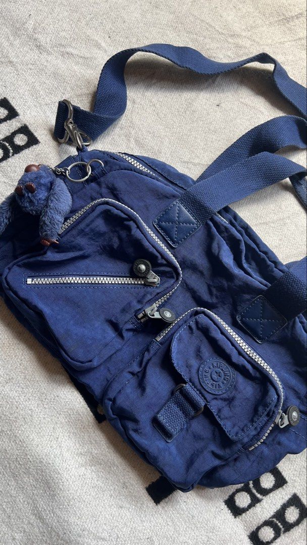 Kipling Defea Backpack Navy Blue with Monkey Charm (Category: Backpacks) located in Cagayan de Oro. Submitted by nelsondel21723 (Listing ID 1449797441, Image 2). Description: - Navy blue Kipling Defea backpack - Multiple pockets for excellent organization - Includes signature Kipling monkey charm - Adjustable straps for backpack or shoulder wear - Zippers are in great working condition - Perfect for daily use or travel.