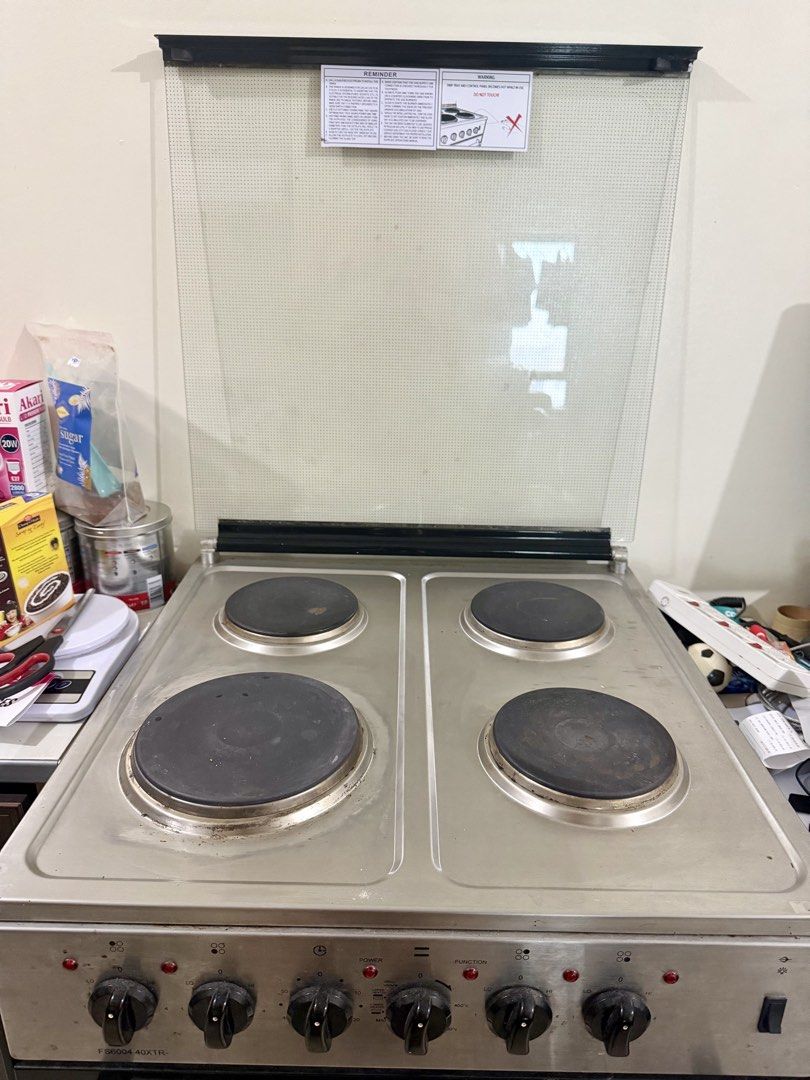 La Germania Oven Stove (Category: Ovens & Toasters) located in Mandaluyong City. Submitted by roy.angelo (Listing ID 1449789621, Image 2). Description: Pickup at Greenfield Mandaluyong c/o buyer - La Germania Oven Stove - Model: FS6004 40XTR - Features 4 electric hobs on top - Includes an oven below - Note: Stains at the bottom plate are due to plastic sticker only.