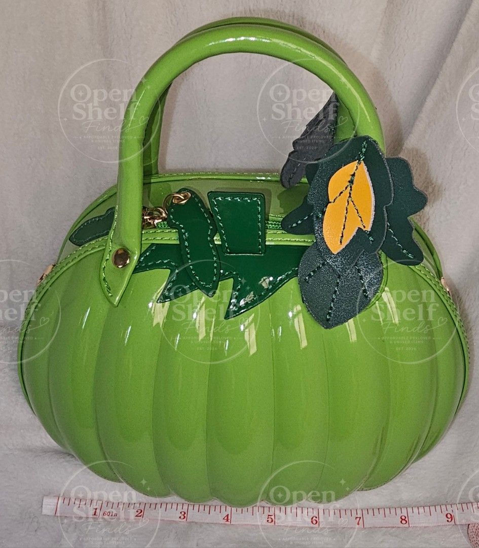 Lime Green Pumpkin Bag with Adjustable Strap (Category: Cross-body Bags) located in Baguio. Submitted by openshelf_findsph (Listing ID 1449753095, Image 3). Description: ‼️PLEASE READ 😊 Condition: Never used, with minimal flaw (small spot discoloration) ✨️ Color: Lime Green ✨️ 3D pumpkin-inspired design with a glossy patent finish ✨️ High-gloss patent PU leather exterior ✨️ Rigid top handle with layered faux-leather leaf accents ✨️ Zippered main