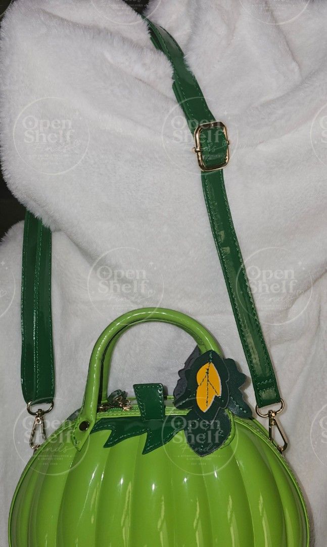 Lime Green Pumpkin Bag with Adjustable Strap (Category: Cross-body Bags) located in Baguio. Submitted by openshelf_findsph (Listing ID 1449753095, Image 2). Description: ‼️PLEASE READ 😊 Condition: Never used, with minimal flaw (small spot discoloration) ✨️ Color: Lime Green ✨️ 3D pumpkin-inspired design with a glossy patent finish ✨️ High-gloss patent PU leather exterior ✨️ Rigid top handle with layered faux-leather leaf accents ✨️ Zippered main