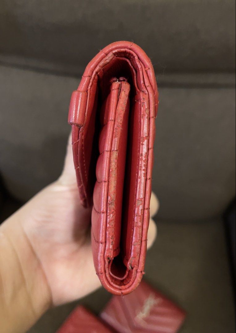 Louis Vuitton Red Leather Wallet (Category: Luxury Bags & Wallets) located in Manila. Submitted by jnjsluxury (Listing ID 1449810123, Image 3). Description: - Authentic red Louis Vuitton wallet - Quilted leather with iconic LV logo - Features a small wrist strap with colorful lettering - Minor wear on edges, as pictured - Plenty of life remaining, perfect for everyday use Heavily used with scuffings on the corners A bit of peeling in the zipper p