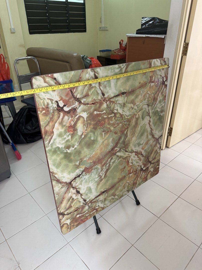 Marble Pattern Folding Table (Category: Tables & Sets) located in Singapore. Submitted by paiyulou (Listing ID 1449777201, Image 2). Description: - Stylish square folding table - Unique green and brown marble-like pattern - Sturdy metal legs fold flat for convenient storage - Ideal for small apartments, dorms, or as extra surface space - Dimensions: Approx. 60cm x 60cm (surface), 75cm (height).