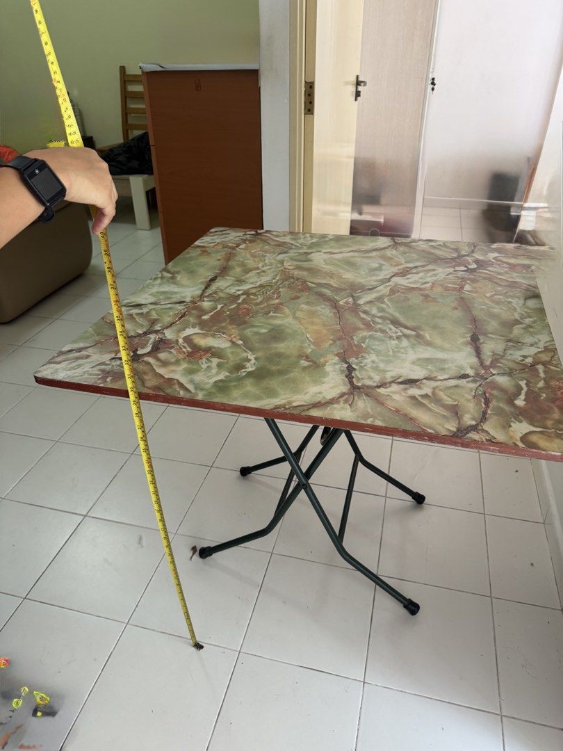 Marble Pattern Folding Table (Category: Tables & Sets) located in Singapore. Submitted by paiyulou (Listing ID 1449777201, Image 1). Description: - Stylish square folding table - Unique green and brown marble-like pattern - Sturdy metal legs fold flat for convenient storage - Ideal for small apartments, dorms, or as extra surface space - Dimensions: Approx. 60cm x 60cm (surface), 75cm (height).