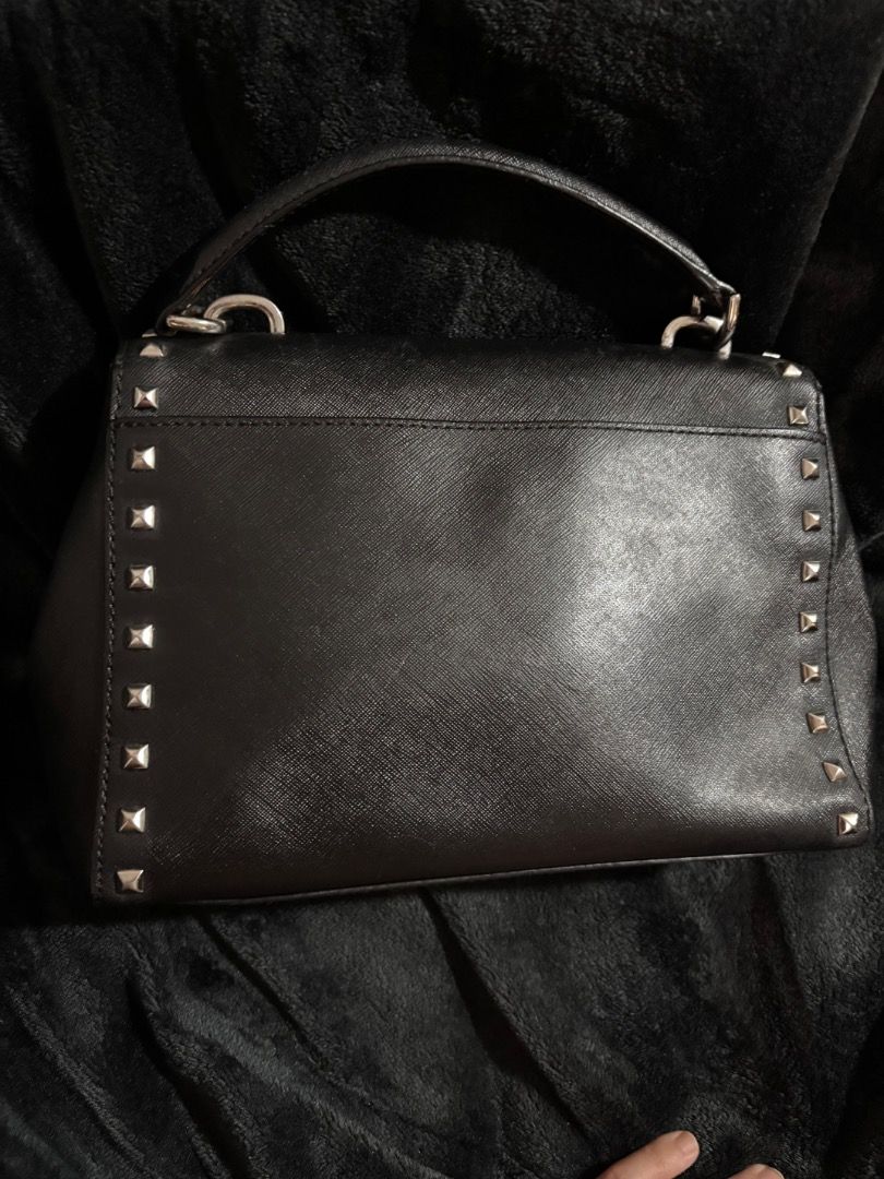 Michael Kors Black Studded (Only 750 until Oct 20) (Category: Luxury Bags & Wallets) located in Pasay City. Submitted by kgemsluxuryboutique (Listing ID 1449822148, Image 2). Description: - Original Michael Kors minimalist handbag in black - Genuine saffiano leather with stylish silver stud details - Versatile: top handle and detachable crossbody strap included - Practical interior zip pocket - Clean interior, ready for its new owner - Ideal for 