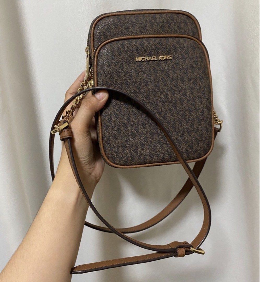 Michael Kors Monogram Crossbody Bag (Category: Luxury Bags & Wallets) located in Pakil. Submitted by anniapatri11075 (Listing ID 1449770631, Image 2). Description: - Classic brown Michael Kors crossbody bag - Signature MK monogram print - Gold hardware details - Adjustable strap for comfortable wear - Zipped compartments for secure storage - Ideal for everyday use or travel.