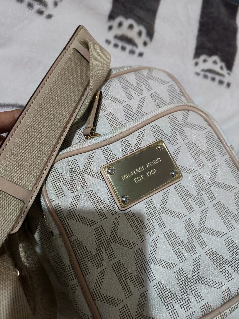 Michael Kors Monogram Crossbody Bag (Category: Luxury Bags & Wallets) located in Manila. Submitted by rochelleci78148 (Listing ID 1449948557, Image 1). Description: - Classic Michael Kors monogram pattern (white/beige) - Gold-tone hardware with MK logo plate - Secure zipper closure - Interior slip pocket for essentials - Adjustable strap for comfortable wear - Ideal for everyday use.