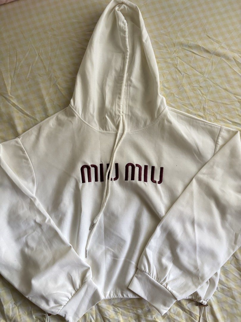Miu Miu White Cropped Hoodie (Category: Luxury Apparel) located in Masbate. Submitted by pinkshoppe.ph (Listing ID 1449947876, Image 1). Description: - White cropped hoodie - Features Miu Miu logo - Drawstring hood and hem for adjustable fit - Long sleeves with elastic cuffs - Super comfy and stylish design - Ideal for everyday casual wear.