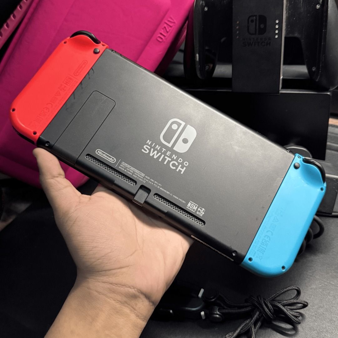 Nintendo Switch V2 complete w/ Games & 1.4K PHP freebies (Category: Nintendo) located in Quezon City. Submitted by consoleciety (Listing ID 1449844147, Image 2). Description: Selling Nintendo Switch V2 complete for ₱9,299 —extremely presentable, 9.5/10 condition | tempered glass installed —no issue, everything working & checked according to my guide on how to buy 2nd hand (posted on T1kT0K) —includes complete accessories [no box] and Orzly Pink c