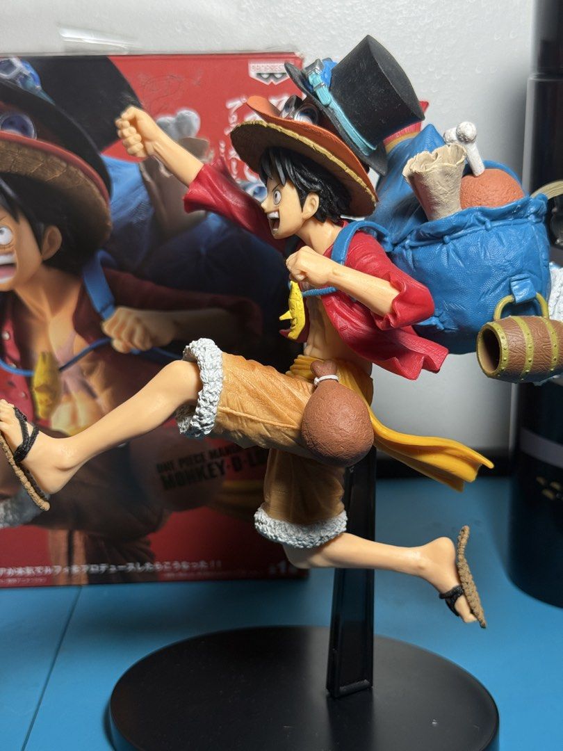 One Piece Monkey D. Luffy & Sabo Action Figure (Category: Figurines & Statues) located in Manila. Submitted by aprilluraine (Listing ID 1443795947, Image 3). Description: - Features Monkey D. Luffy and Sabo in dynamic action poses. - Luffy is depicted in his iconic red shirt and straw hat. - Sabo is layered on top, wearing his top hat and goggles. - Includes a black display stand for easy showcasing. - no scratches, dents, or missing parts - BOB.