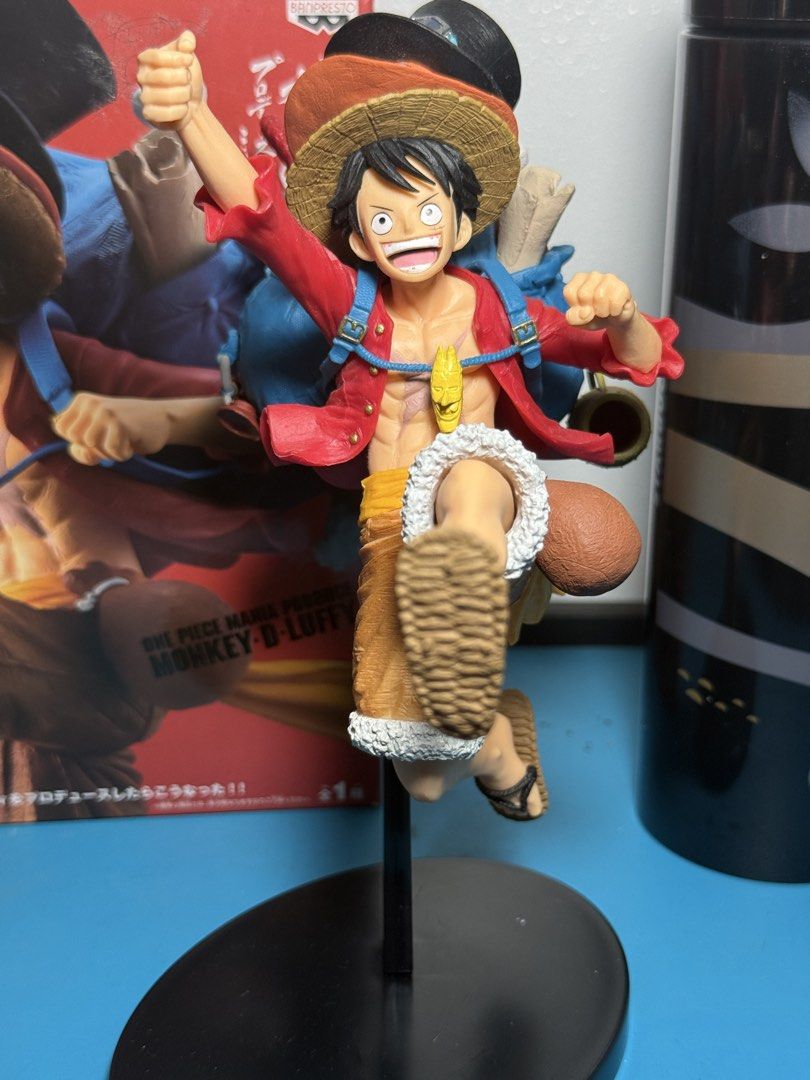 One Piece Monkey D. Luffy & Sabo Action Figure (Category: Figurines & Statues) located in Manila. Submitted by aprilluraine (Listing ID 1443795947, Image 2). Description: - Features Monkey D. Luffy and Sabo in dynamic action poses. - Luffy is depicted in his iconic red shirt and straw hat. - Sabo is layered on top, wearing his top hat and goggles. - Includes a black display stand for easy showcasing. - no scratches, dents, or missing parts - BOB.