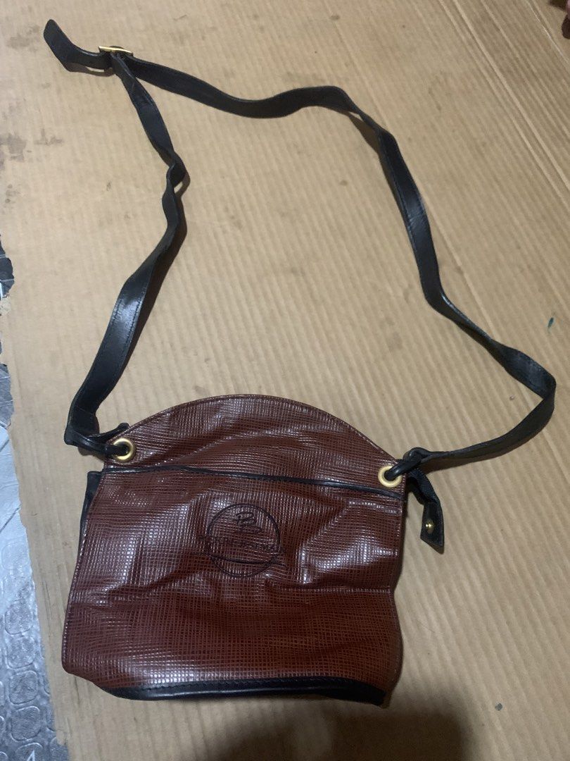 Pierre Balmain Paris Leather Crossbody Bag (Category: Luxury Bags & Wallets) located in Cagayan de Oro. Submitted by agboysalis60090 (Listing ID 1449780539, Image 1). Description: Brown and black leather crossbody bag. Features the Pierre Balmain Paris logo embossed on the front. Adjustable strap. Zipper closure. Interior has a branded tag. Some signs of wear on the strap and leather..