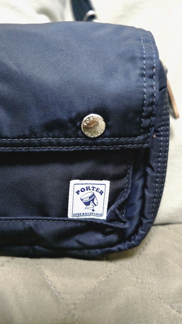 Porter Sling Bag (Detachable Strap) (Category: Luxury Bags & Wallets) located in Manila. Submitted by rueruepot (Listing ID 1449814703, Image 2). Description: - Navy blue Porter wallet pouch - Detachable strap included - Bright orange interior with multiple compartments - Secure zip closure - Ideal for organizing essentials - Great for travel or everyday use NEGOTIABLE Location: Manila/Bulacan RFS: Unloading.