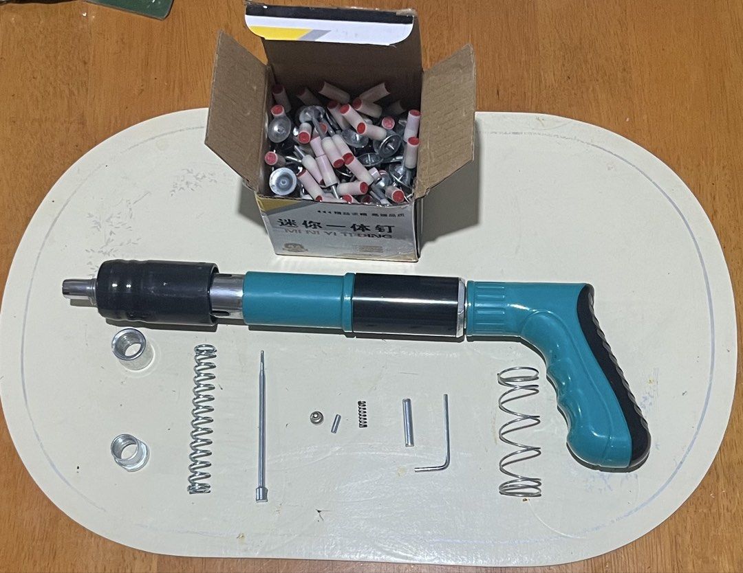 Powder Actuated Tool Nail Gun with Assorted Fasteners and Tools (Category: Construction Tools & Equipment) located in Pasig City. Submitted by jerryind107 (Listing ID 1449749484, Image 1). Description: - Powder actuated nail gun - Box of nails included - Assorted wall plugs, screws, and eye hooks - Set of pliers, screwdrivers, and adjustable wrench - Perfect for construction and DIY projects Sanitary items newly packed - All items as pictured.