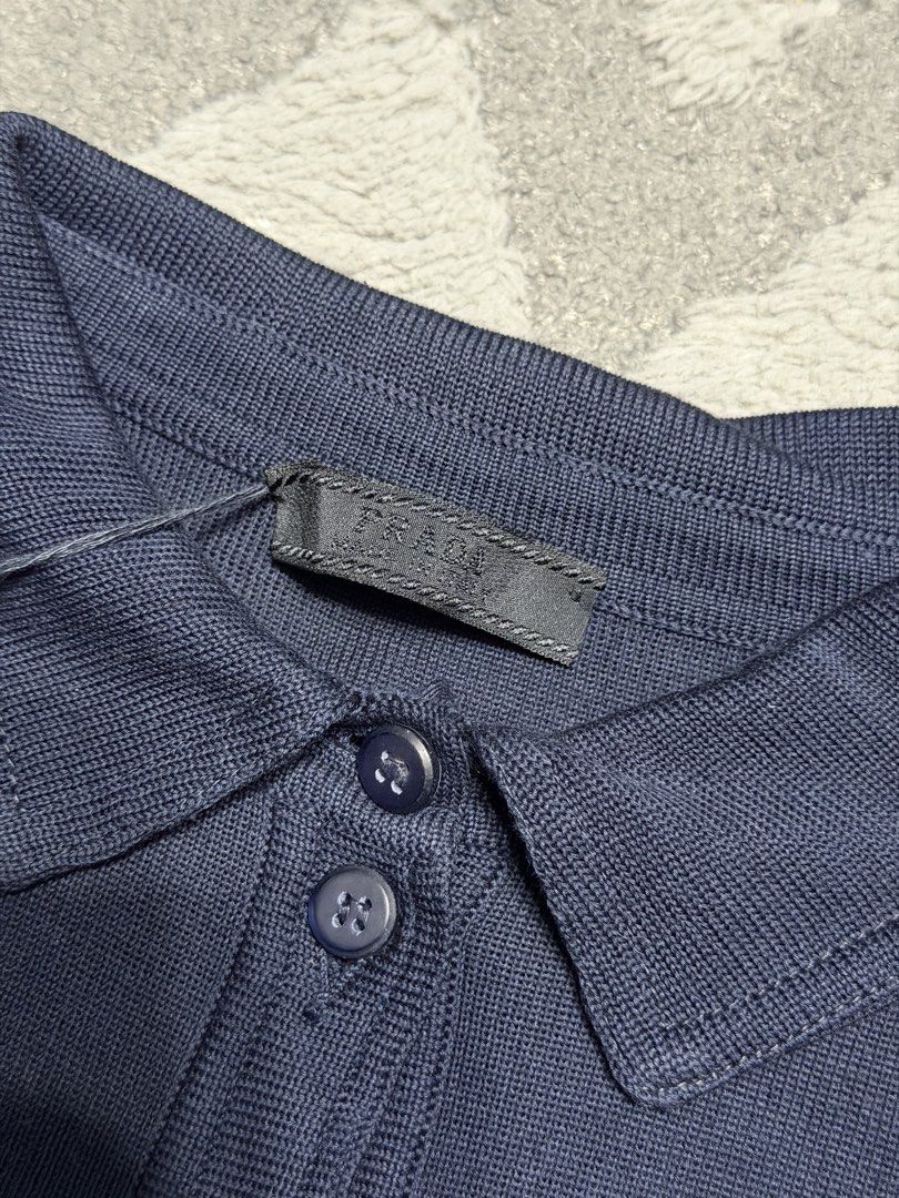 Prada - Navy Blue Pocket Knit Utility Shirt (Category: Blouses) located in Cavite. Submitted by commoncourtesy (Listing ID 1449765736, Image 3). Description: Authentic Size 38 Brandnew with tags Length: 20 inches Width: 18 inches (stretchable siya) Shoulder to shoulder:15 inches Pit to pit: 18.5 inches Armhole: 4 inches Sleeve Length: 8 inches.