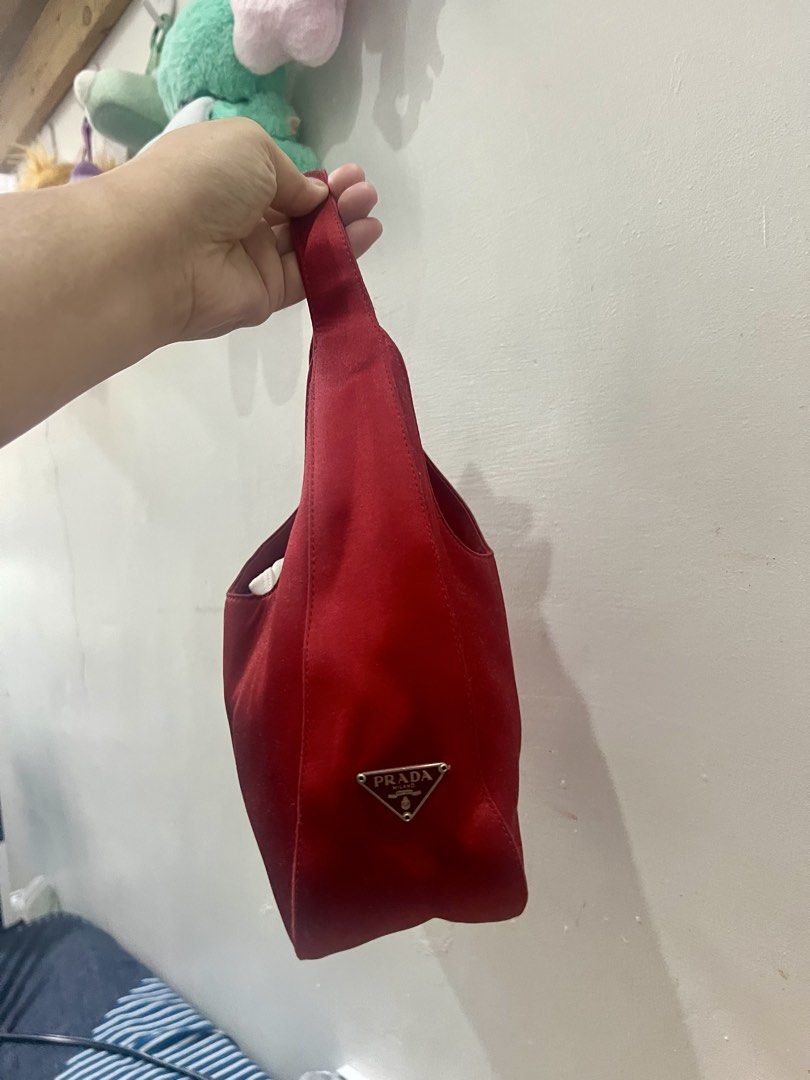 Prada Red Satin Mini Bag (Category: Luxury Bags & Wallets) located in Manila. Submitted by gailmg (Listing ID 1449865620, Image 3). Description: - Thrifted from Japan - Self Authenticated / NGA - Has white tag - Luxurious Satin Material - Compact Size: Ideal for essentials - Iconic Prada Logo Embellishment - Comfortable Handle for easy carrying - Stylish and versatile for any outfit or occasion, especially nights out - Slight stitching issue on t