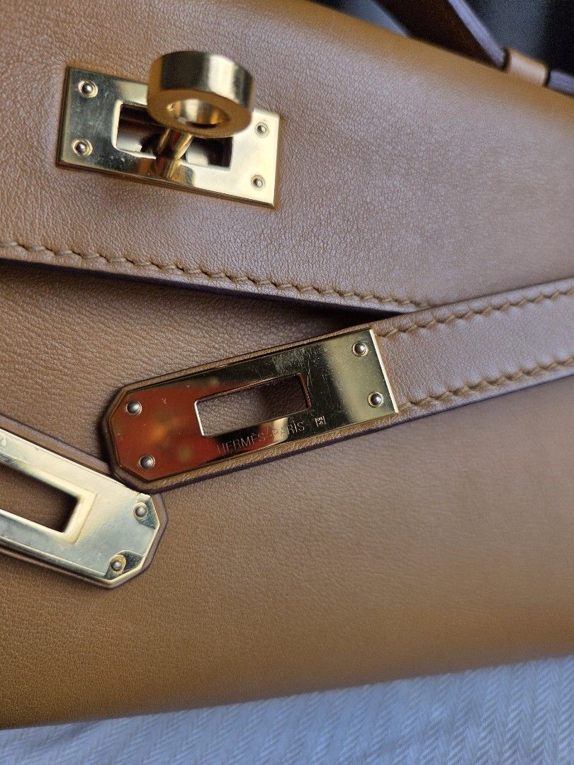 Preloved Hermes Kelly Cut Clutch (Category: Luxury Bags & Wallets) located in Quezon City. Submitted by shop.mar.go (Listing ID 1449785784, Image 2). Description: preloved Hermes Kelly Cut Clutch biscuit swift in gold hardware comes with dust bag and legit grails certificate stamp Y ( year 2020) has minor dirt marks, and signs of usage. but barely noticeable. perfect for events, evening bag, etc. perfect neutral color!.