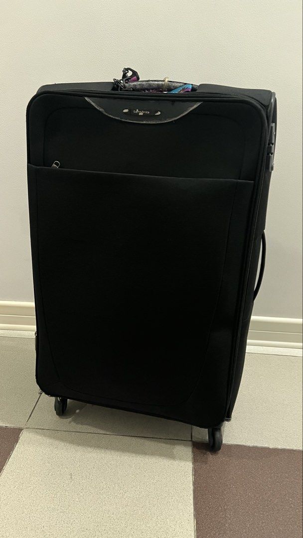Preloved: Samsonite Super Light Large Luggage (Category: Luggage) located in Manila. Submitted by irockmysocks_ogee (Listing ID 1449757005, Image 1). Description: - Large Samsonite spinner luggage in black - Ideal for extended travel - Interior features mesh pockets and securing straps for organization - Convenient front zip pocket on the exterior - Wheels roll smoothly for easy maneuverability.