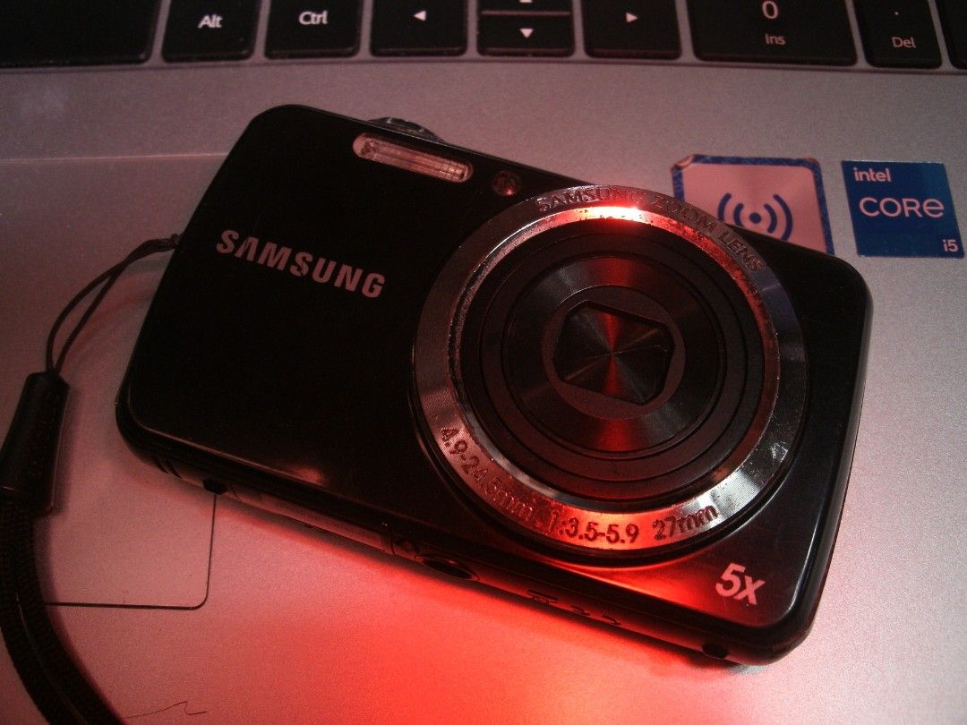 Samsung Digital Camera 5x Optical Zoom (Category: Cameras) located in Muntinlupa City. Submitted by cjcalcifier (Listing ID 1449882587, Image 3). Description: - Black Samsung defective digital camera - 5x optical zoom lens - LCD blackout - Ideal for casual use or as a backup camera - Comes with a wrist strap.
